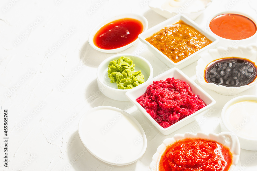 Set of different sauces - ketchup, mayonnaise, barbecue, soy, chutney, wasabi, adjika, horseradish Set of different sauces - ketchup, mayonnaise, barbecue, soy, chutney, wasabi, adjika, horseradish