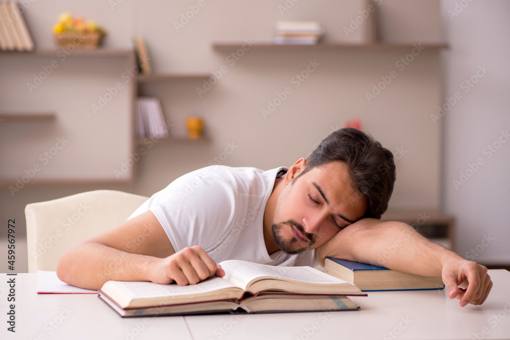Young male student studying at home during pandemic Young male student studying at home during pandemic
