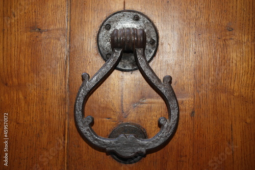 Vintage brass door knocker on an old door, Italy, Florence