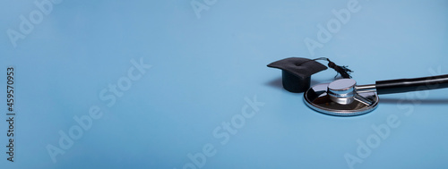 Stethoscope and graduate hat, on a blue background, top view, medical background graduate achievement, background, banner