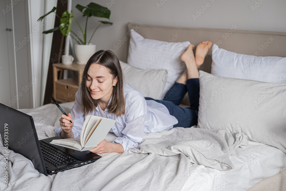 The girl works from home. Online work. Remote work The girl works from home. Online work. Remote work