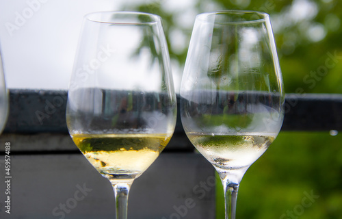 Glass of white wine on a table outside.