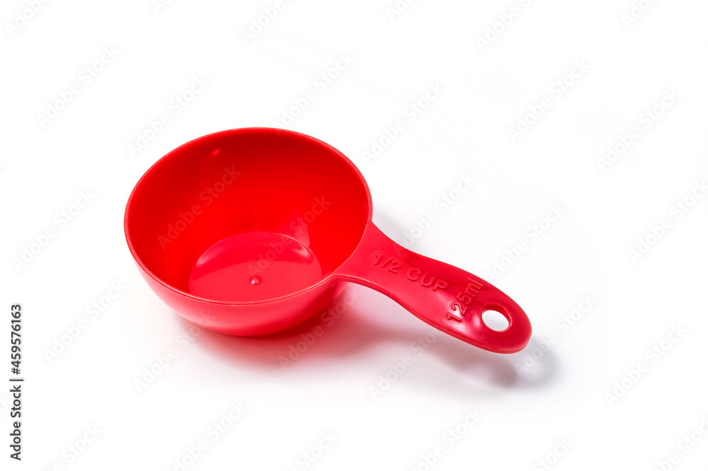 Red ingredient measuring scoop or spoon - half size. Isolated on white background with Clipping path Red ingredient measuring scoop or spoon - half size. Isolated on white background with Clipping path