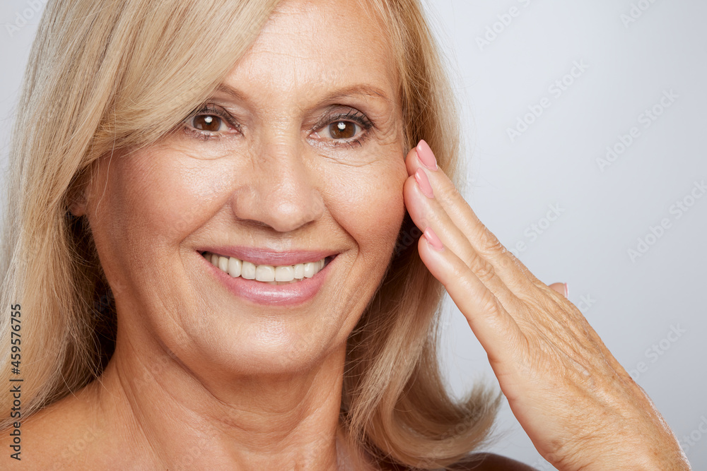 Close up of a beautiful senior lady touching her soft wrinkled skin. Beauty photography Close up of a beautiful senior lady touching her soft wrinkled skin. Beauty photography