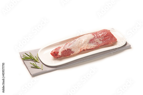 solomillo de cerdo fresco crudo en un plato bandeja blanca con una servilleta de tela gris y hierbas decorativas, aislada fondo blanco photo