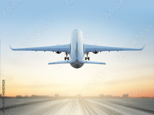 Commercial aircraft above runway on evening sky background with beautiful sunset. Back view. 3d render.