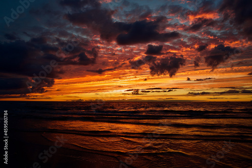 Colorful sunset with clouds by the sea