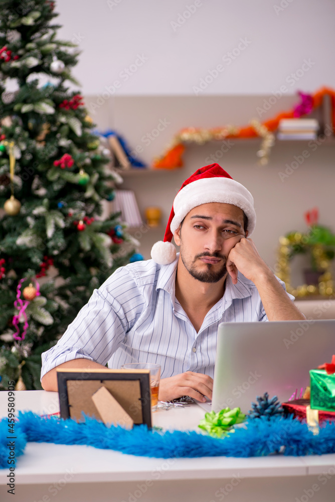Young man celebrating Christmas at home alone Young man celebrating Christmas at home alone