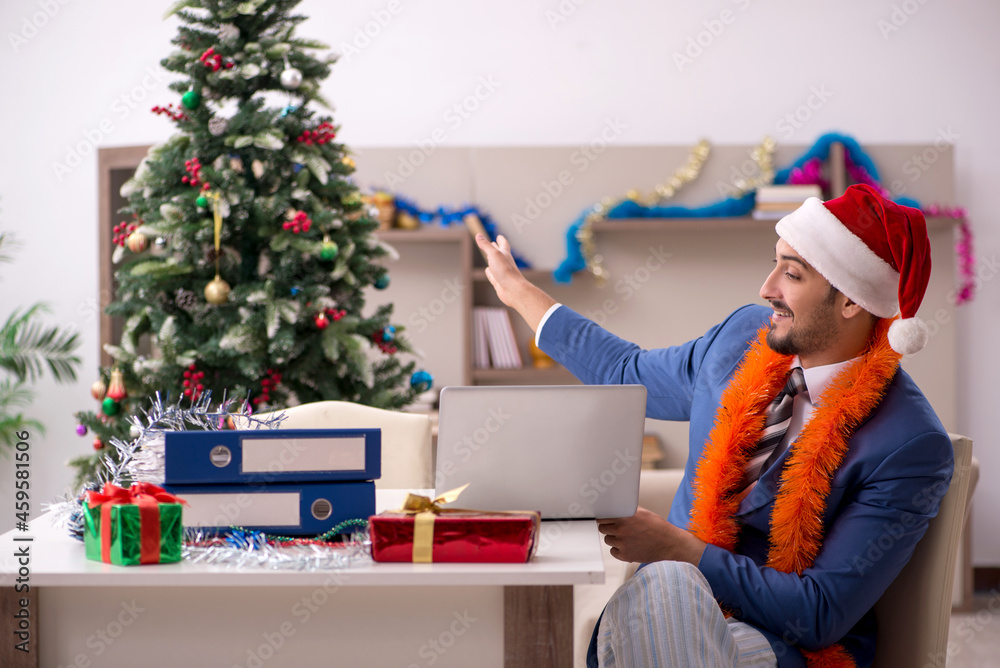 Young businessman working from home at Christmas eve Young businessman working from home at Christmas eve