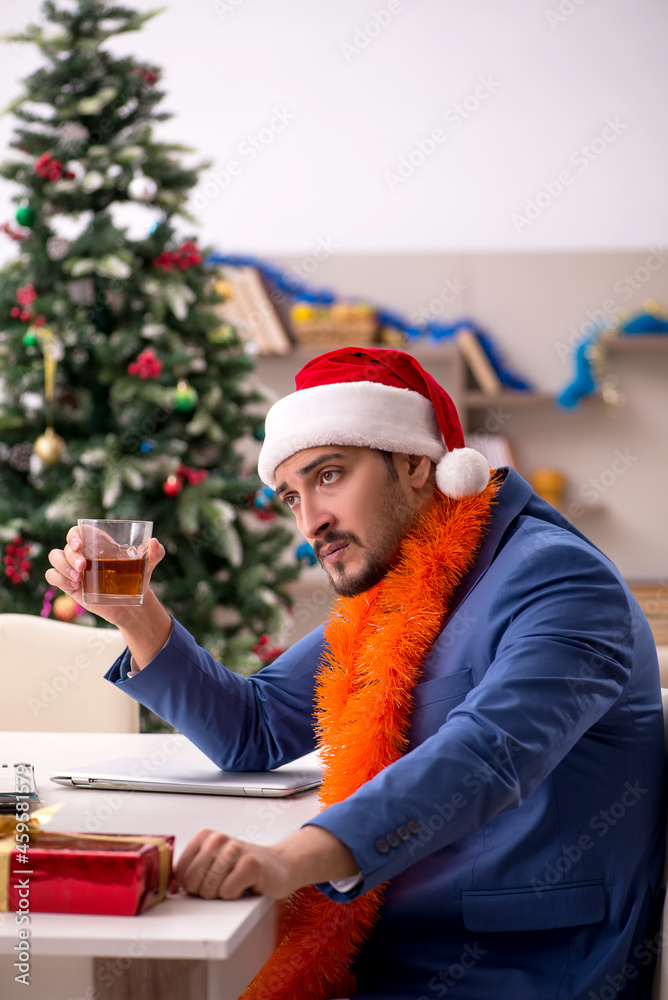 Young businessman working from home at Christmas eve Young businessman working from home at Christmas eve