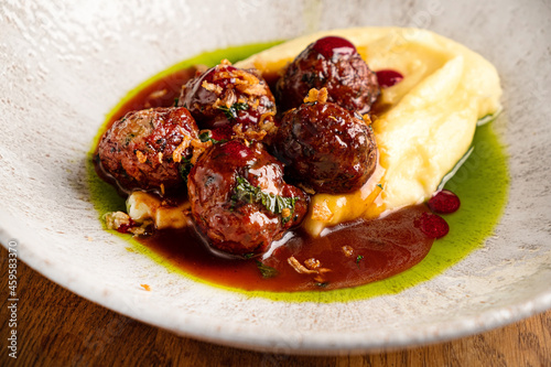 beef meatballs with mashed potato and cranberry sauce