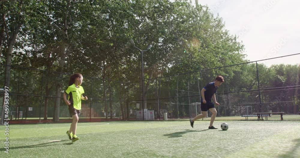 Father and daughter playing football on soccer field,4K Father and daughter playing football on soccer field,4K