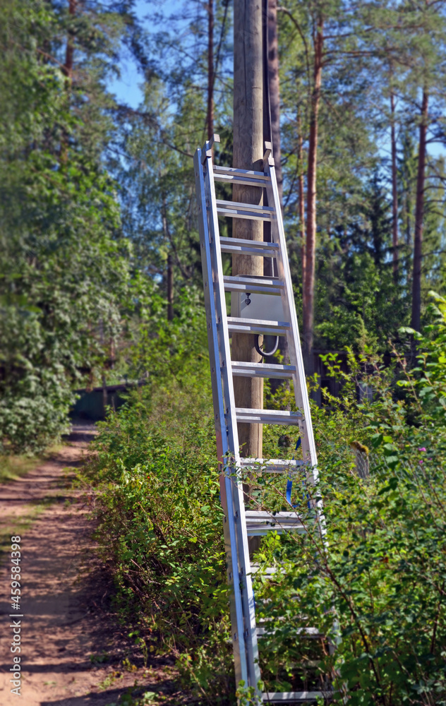 ladder leaned against electric pole ladder leaned against electric pole