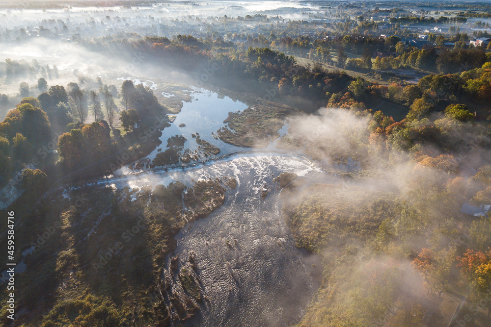 Venta waterfall in the fog in sunny autumn morning, Kuldiga, Latvia. Captured from above.