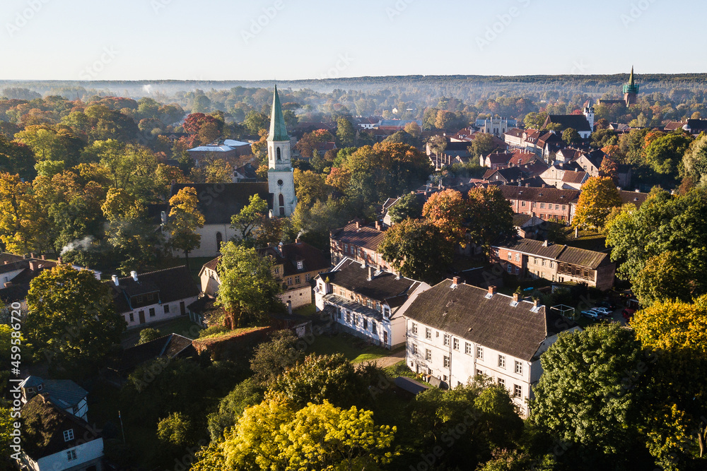 Aerial view of old town in city Kuldiga, lutheran church and red roof tiles, Latvia. Sunny autumn morning.