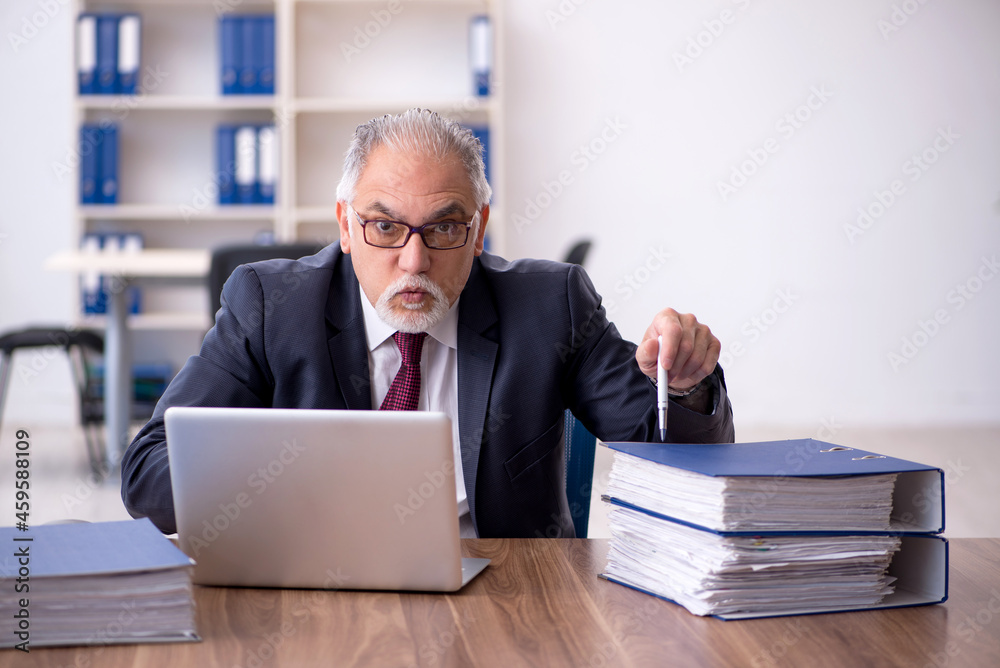 Old male employee and too much work in the office Old male employee and too much work in the office
