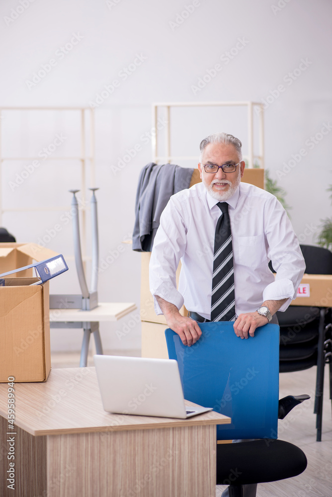 Old male employee in relocation concept Old male employee in relocation concept