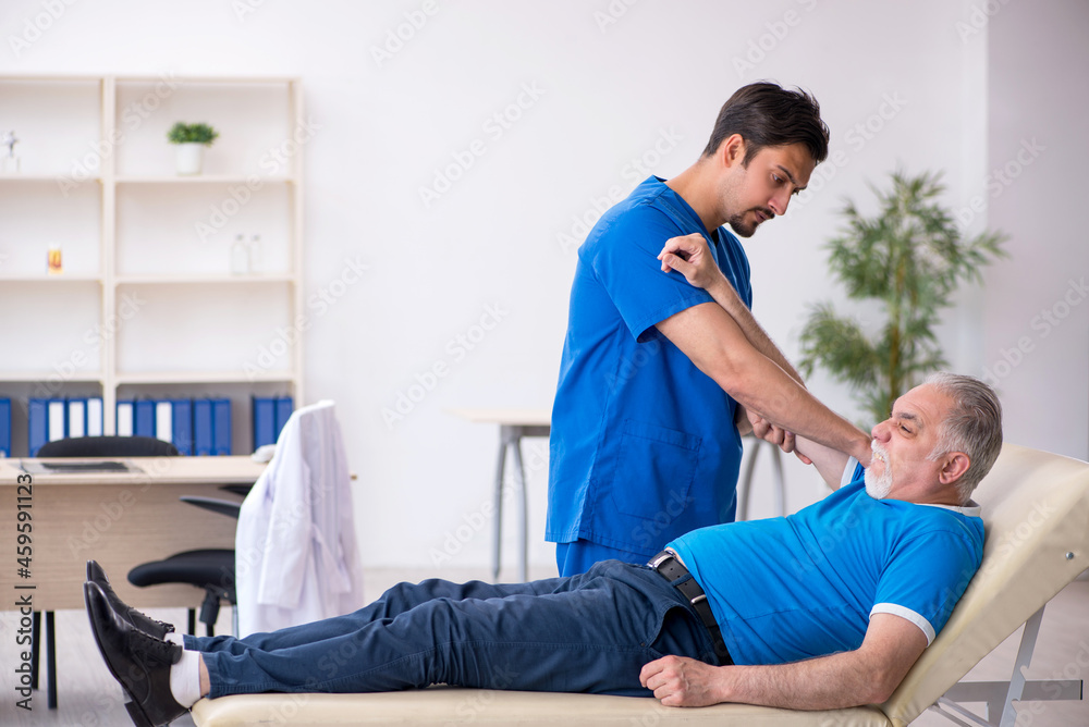 Old male patient visiting young male doctor Old male patient visiting young male doctor