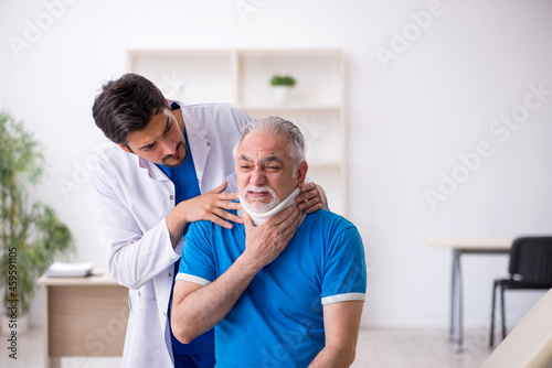 Old neck injured male patient visiting young male doctor
