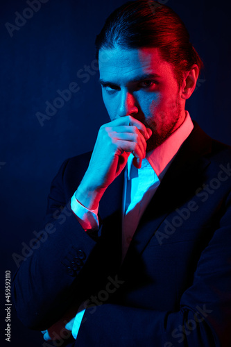portrait of a man gestures with his hands attractive look neon light