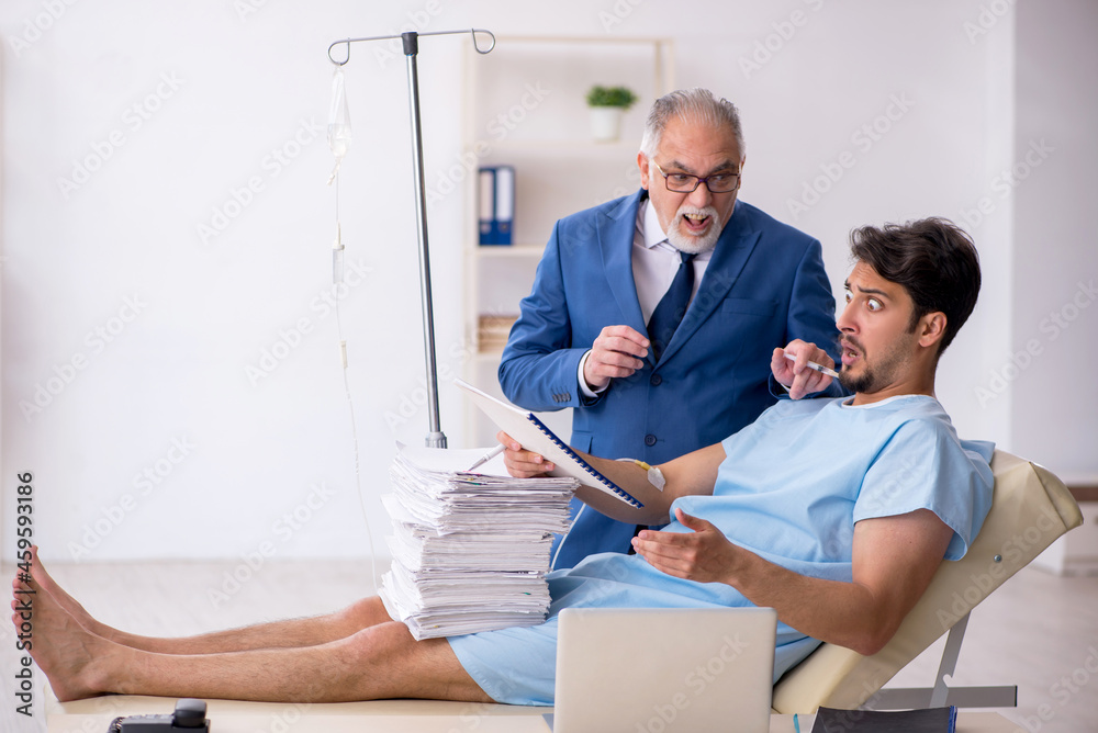 Fototapeta premium Young male employee feeling bad at workplace