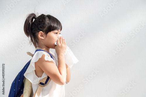 Photography Asian child girl sick with sneezing on the nose and cold cough on tissue paper b