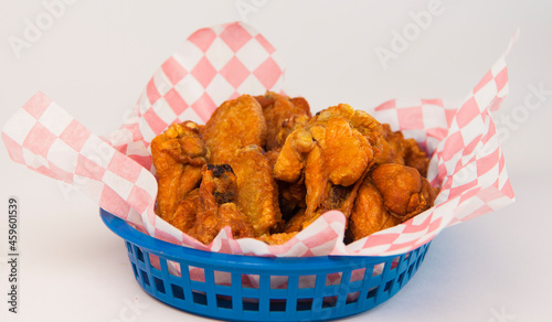 Chicken boneless nuggets basket with checkered patter paper on a white background