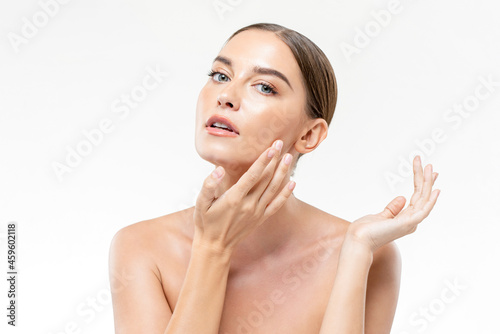 Fresh and clean skin woman touching her face in white isolated studio background for beauty and skincare concepts