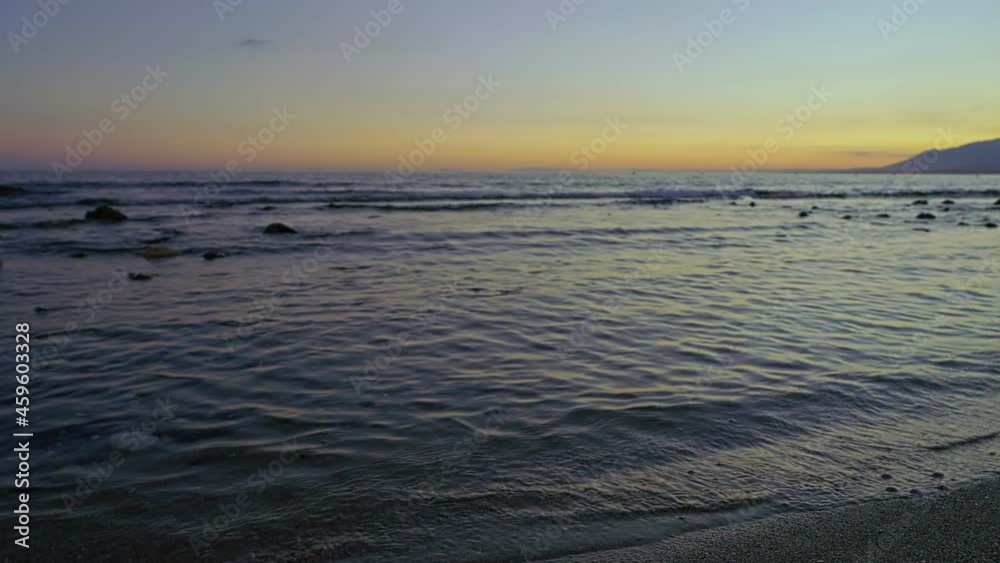 Ocean waves at the beach during sunset Ocean waves at the beach during sunset