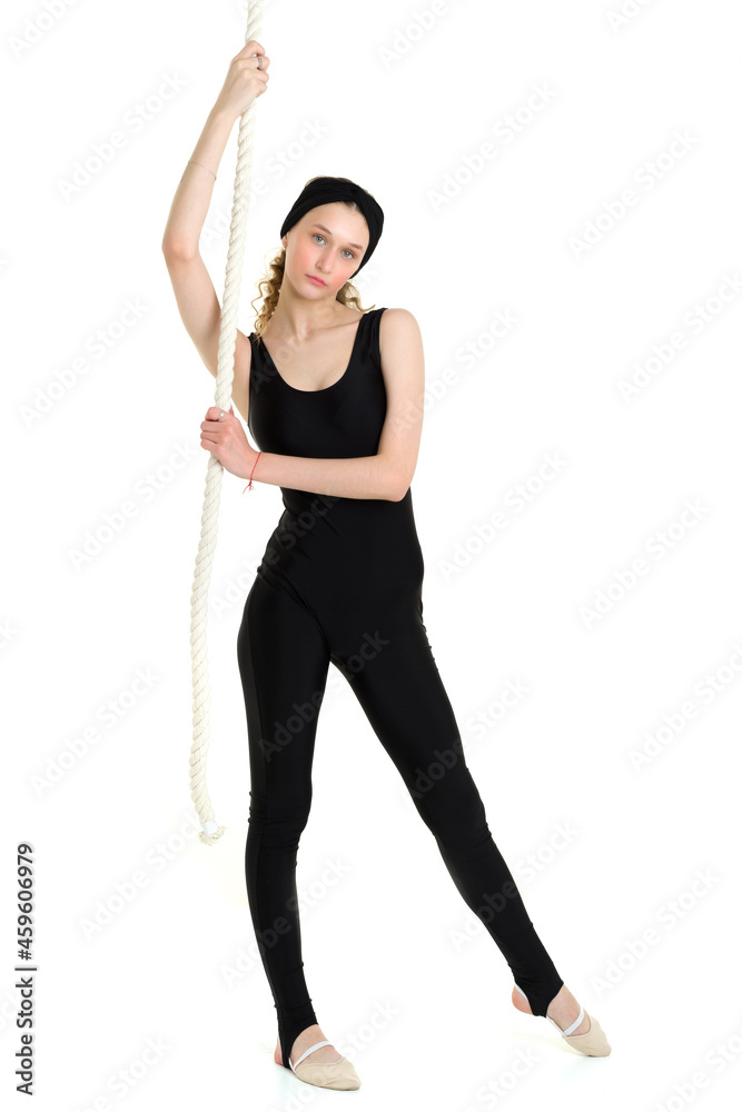 Slim teenage girl gymnast training with rope swing Slim teenage girl gymnast training with rope swing