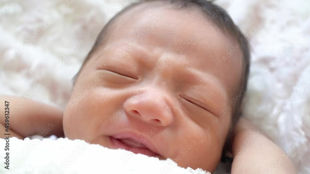 Close up cute newborn baby wake up in white background Close up cute newborn baby wake up in white background