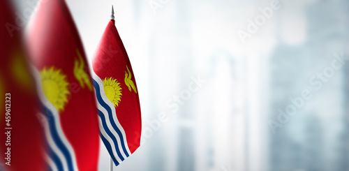 Small flags of Kiribati on a blurry background of the city