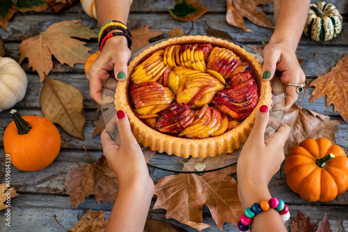 Homemade autumn pies at the hands of two women