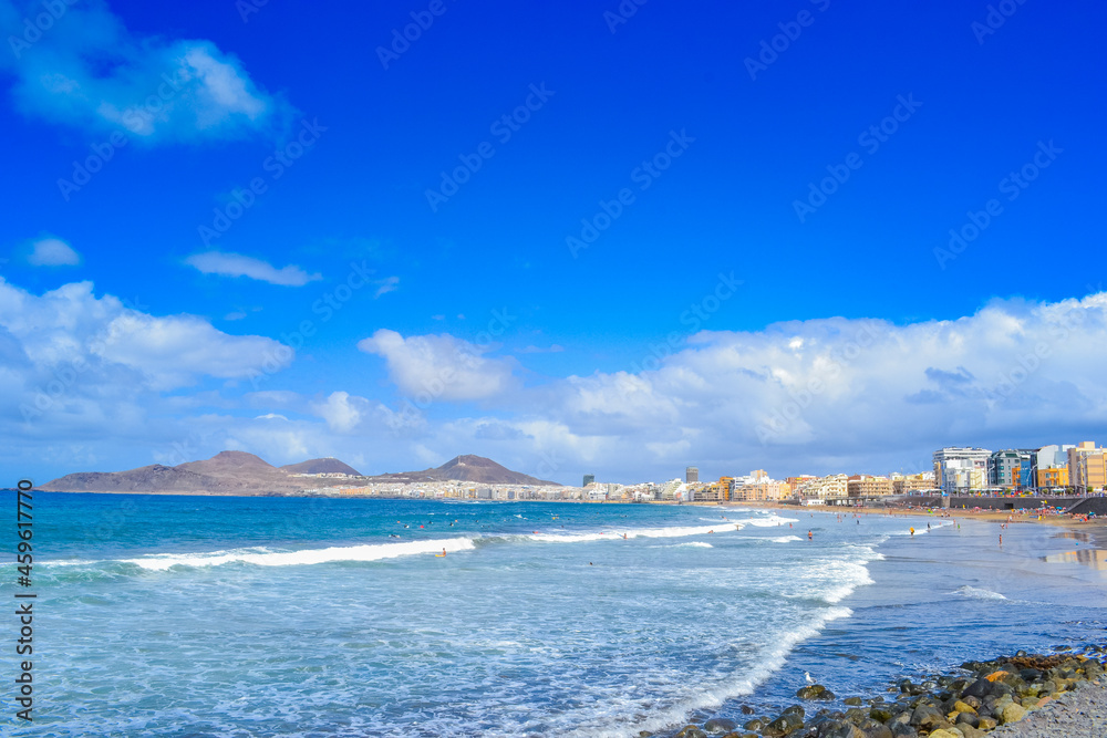 Las Palmas beach, white foam waves and high blue sky