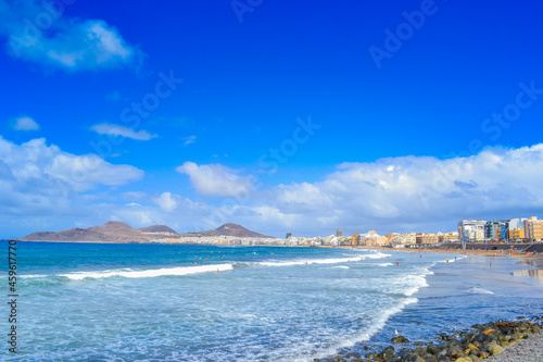 Las Palmas beach  white foam waves and high blue sky