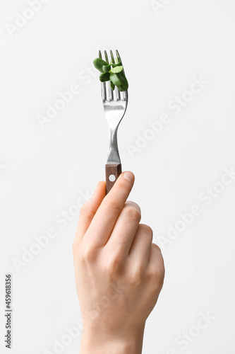 Woman holding fork with fre...