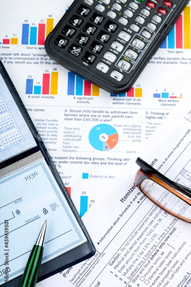 Calculator, Pen and Checkbook on Business Graphs Calculator, Pen and Checkbook on Business Graphs