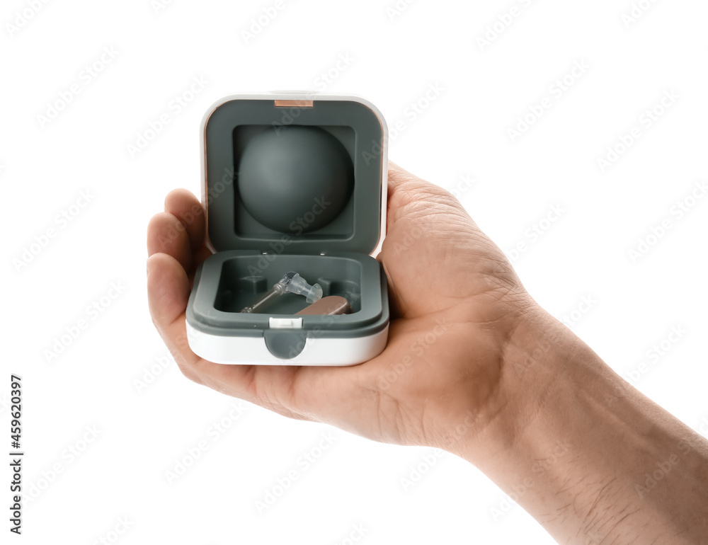 Man holding box with hearing aid on white background Man holding box with hearing aid on white background