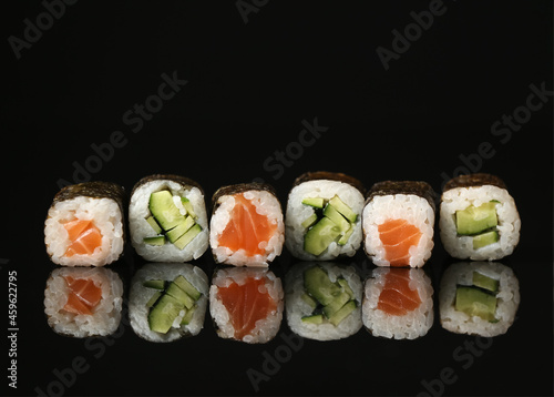 Set of different maki rolls on dark background