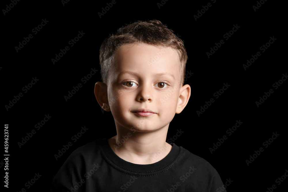 Portrait of cute little boy on dark background Portrait of cute little boy on dark background