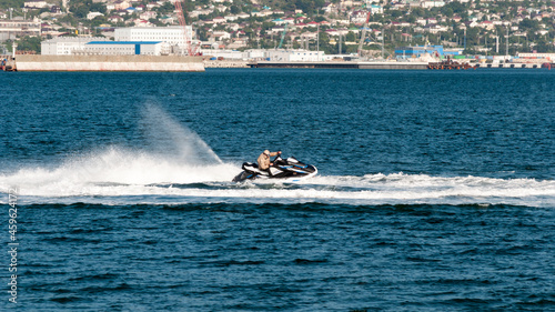 a jet ski rides on the sea waves. seascape with a jet ski. The aquabike floats on the waves of the sea.