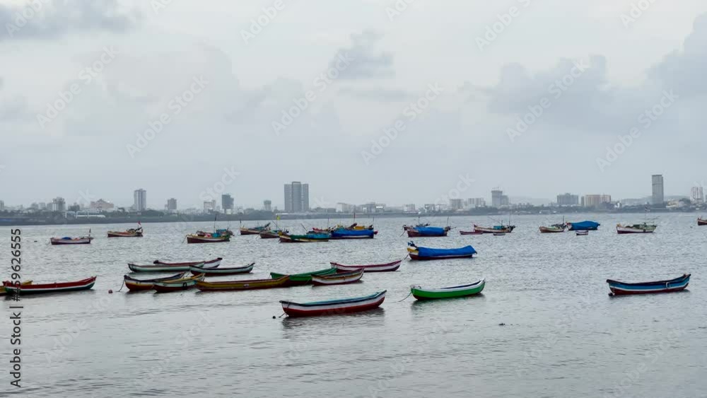 Small Wooden Fishing Boats Floating At Mahim Bay In Mumbai, Maharashtra, India. - wide shot