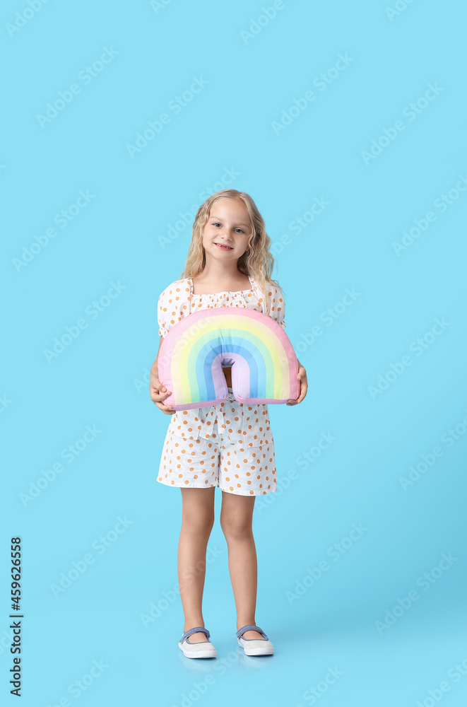 Cute little girl with toy rainbow on color background Cute little girl with toy rainbow on color background