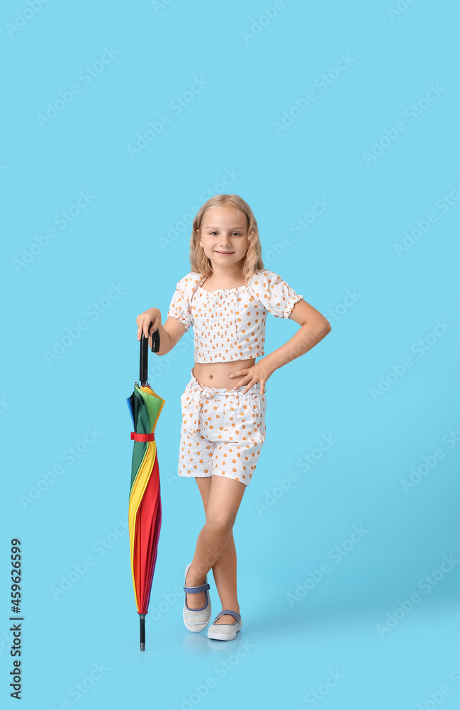 Cute little girl with umbrella on color background Cute little girl with umbrella on color background