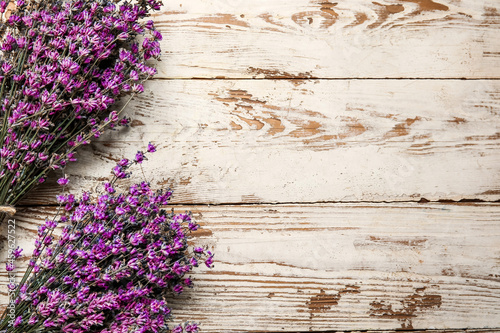 Bouquets of lavender flowers on light wooden background  closeup