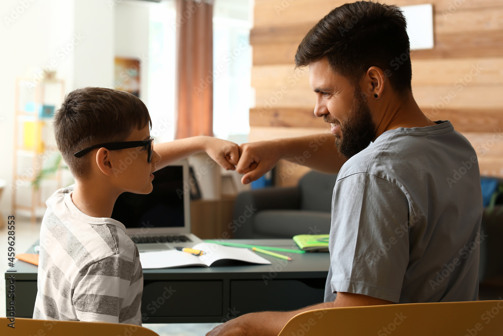 Little boy with his father doing lessons at home Little boy with his father doing lessons at home