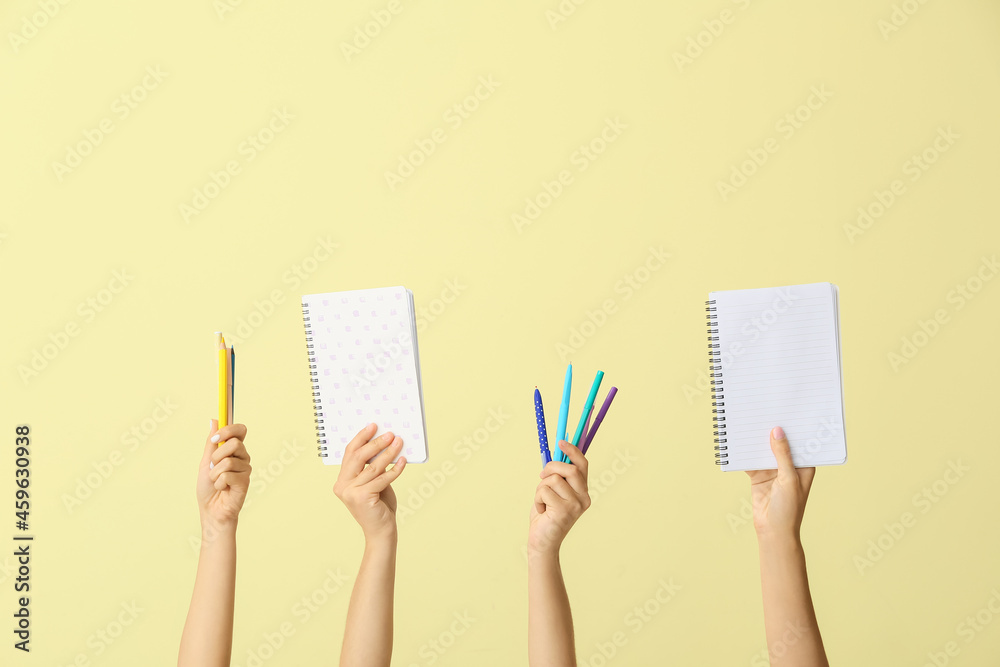 Many different hands with school supplies on color background