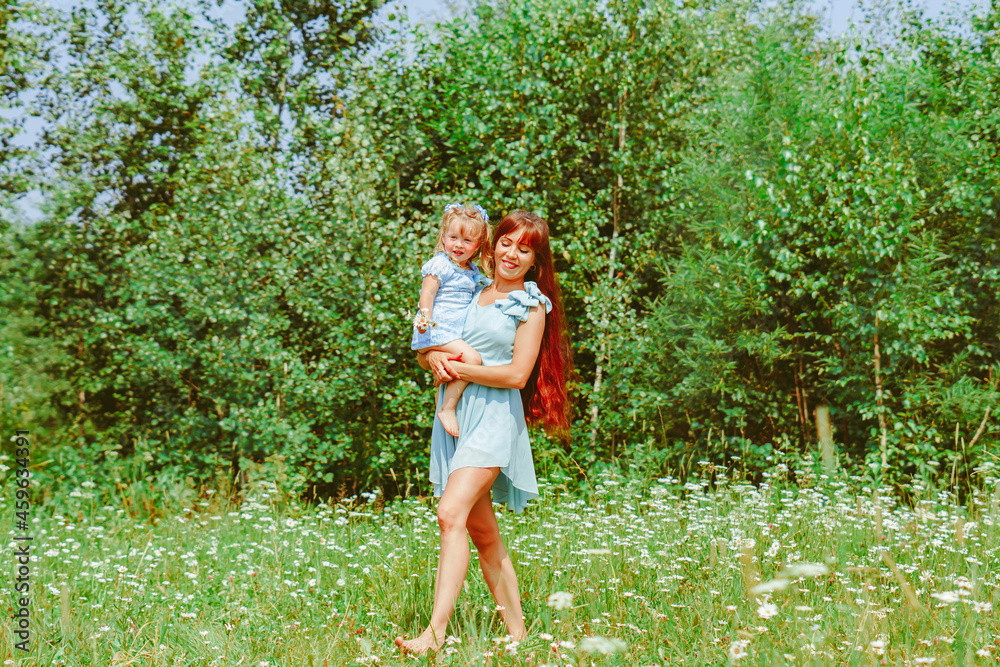 Fototapeta premium mom hugs her daughter in nature