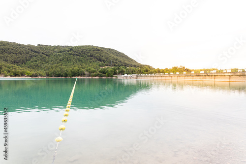 Landscape of the swamp of San Ponç. Sunlight hitting the wall, and green water. photo