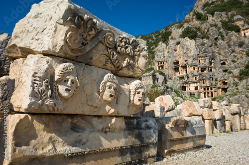 Ruins of ancient city of Myra in Demre, Turkey. Theatrical masks and faces relief and ancient rock tombs in Lycia region photo